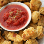 Italian style chicken nuggets with marinara sauce on a white plate