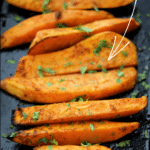 chili lime roasted sweet potato wedges in a small roasting pan