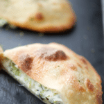 broccoli and cheese calzone cut in half