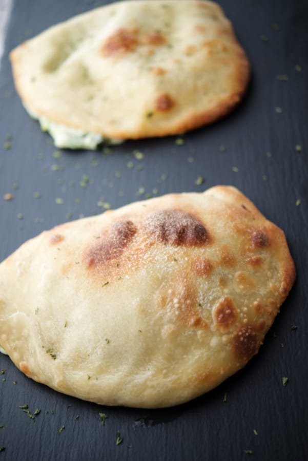 two calzones on a gray tile