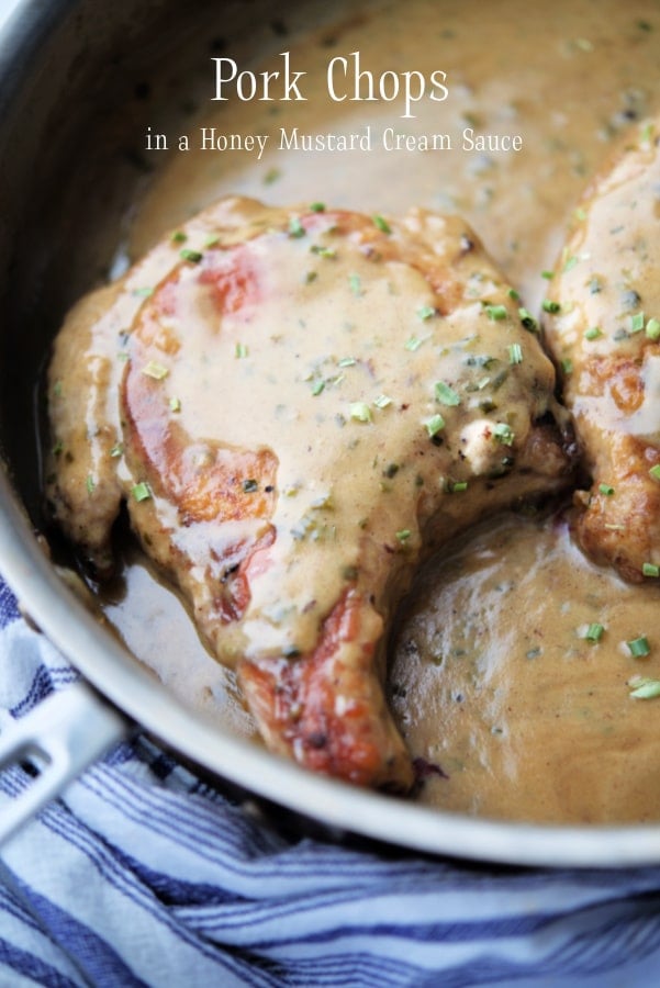 pork chops in a pan with sauce