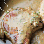 pork chops in a honey mustard cream sauce in a skillet