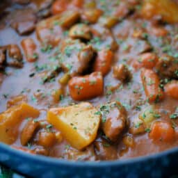 a close up of irish beef stew in a dutch oven