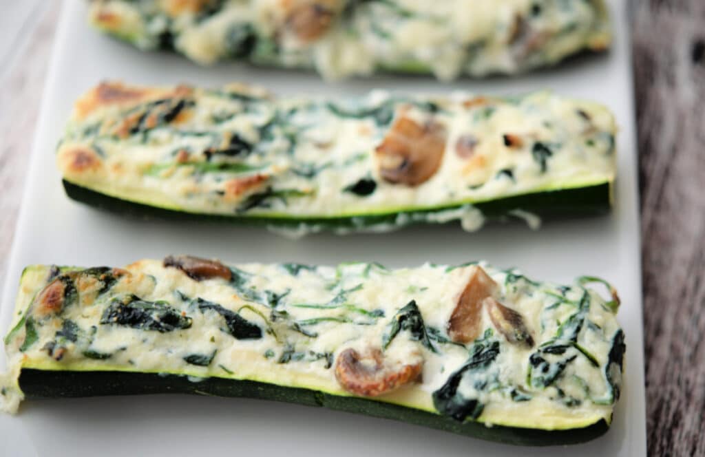 a close up of zucchini boats stuffed with spinach and ricotta cheese