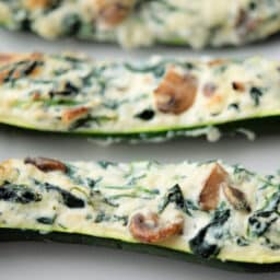 a close up of zucchini boats stuffed with spinach and ricotta cheese