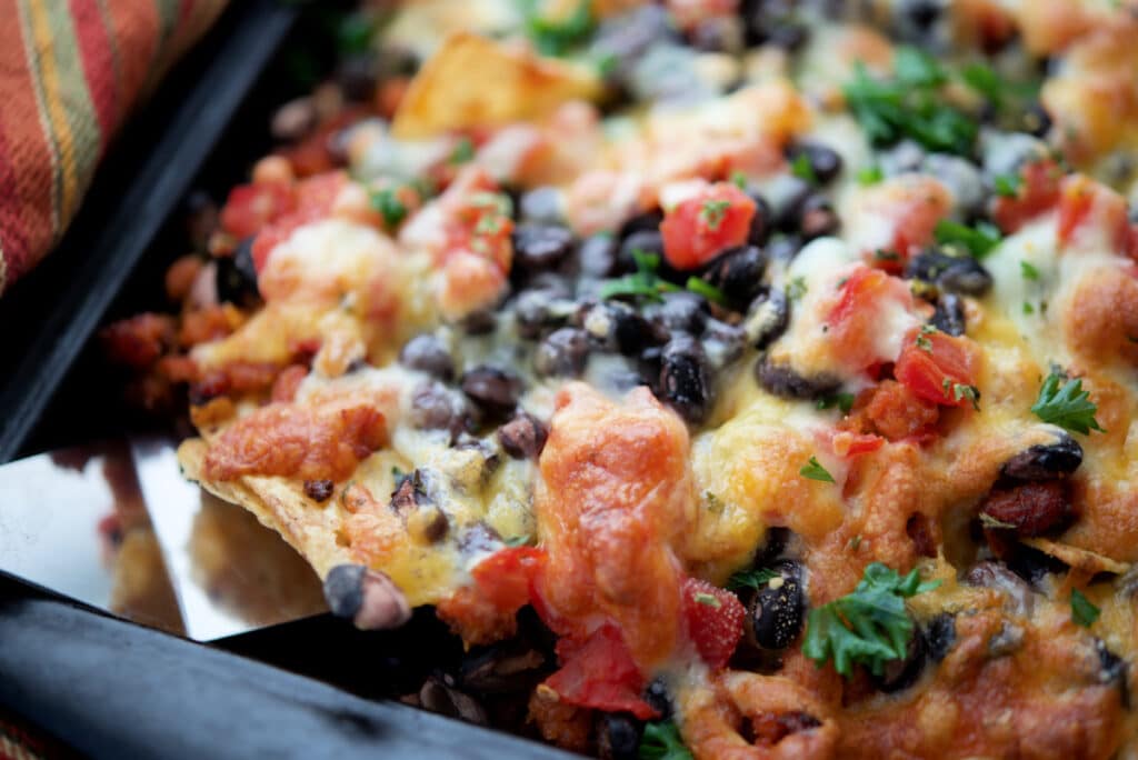 a close up of nachos on a spatula