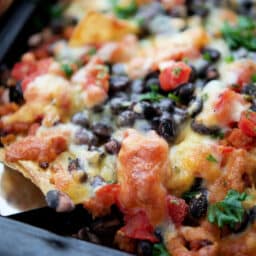 a close up of nachos on a spatula