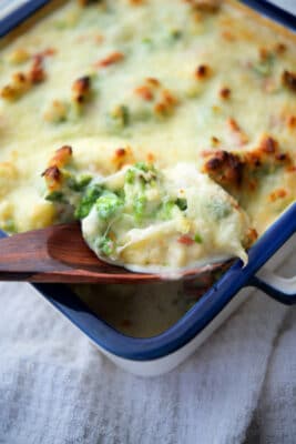 broccoli and cauliflower with a gorgonzola cream sauce on a wooden spoon