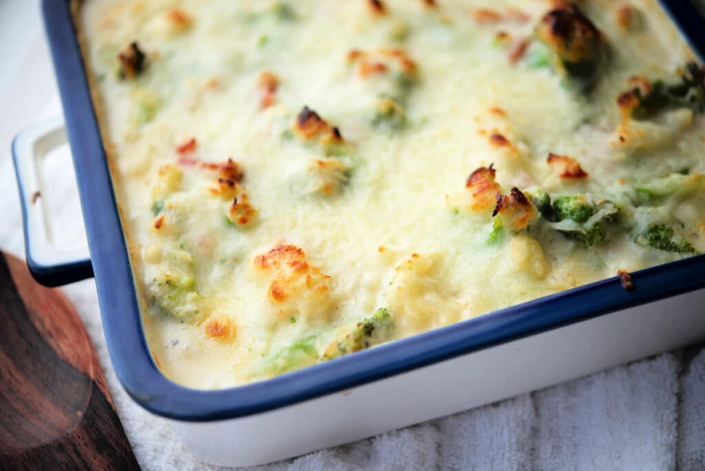 a close up of broccoli and cauliflower in a gorgonzola cream sauce