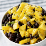 a bowl filled with mango black bean salsa