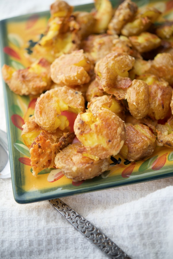 smashed potatoes on a green and yellow plate