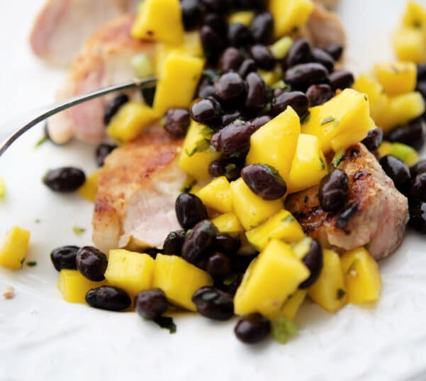 grilled pork chops topped with mango black bean salsa