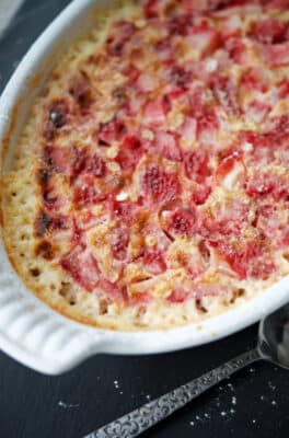 a white baking dish with strawberries and cream baked oatmeal