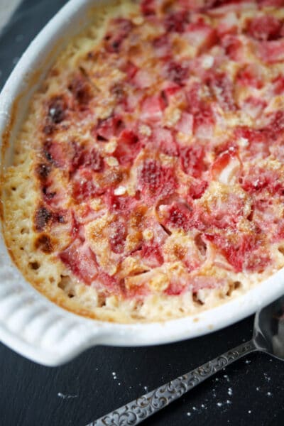 a white baking dish with strawberries and cream baked oatmeal