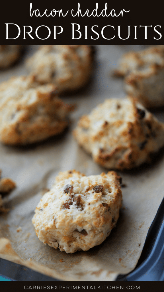 several bacon cheddar drop biscuits on a sheet pan