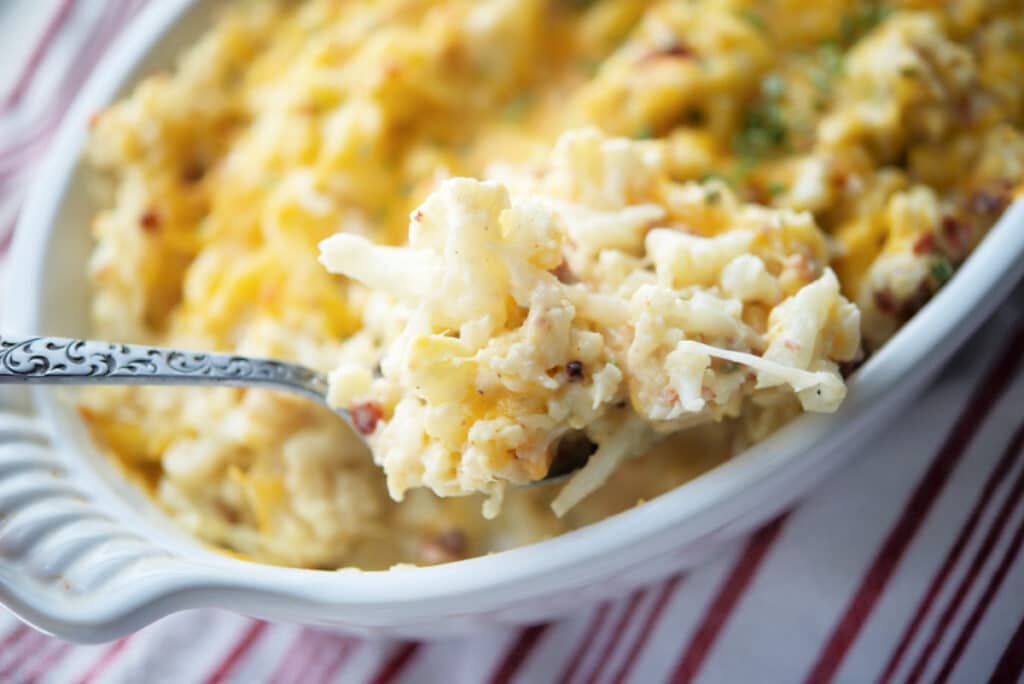 a close up of mashed cauliflower casserole on a spoon