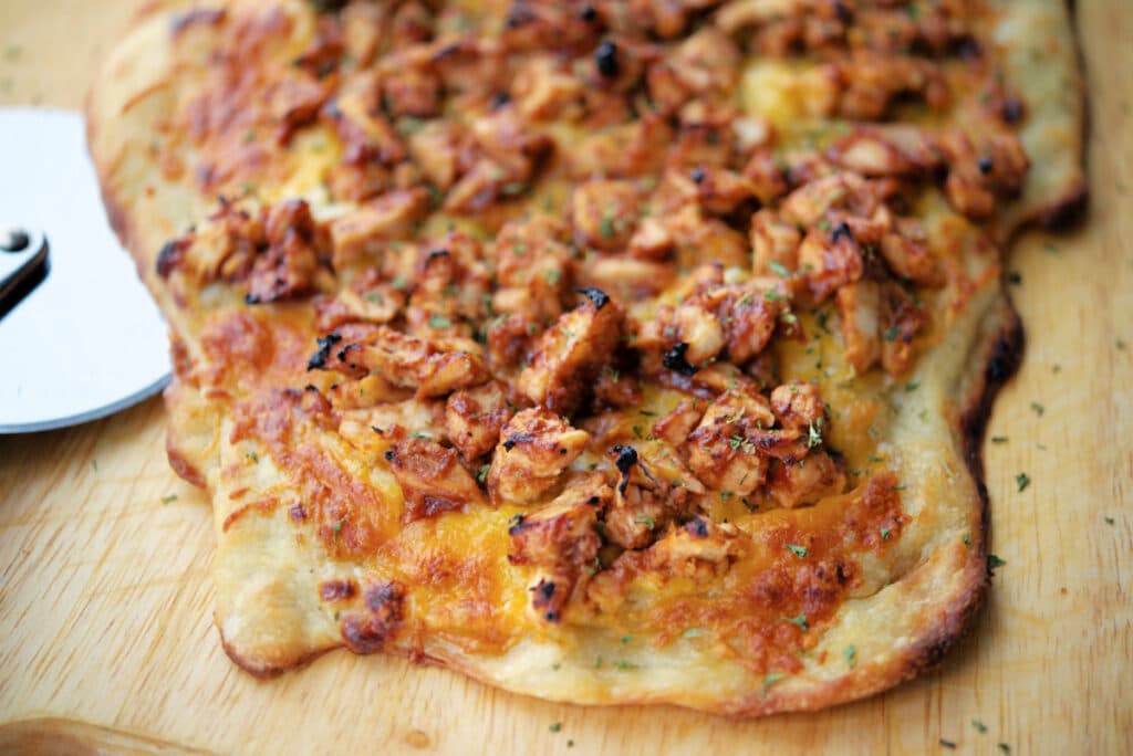 a close up of bbq chicken flatbread