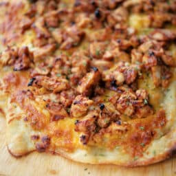 a close up of bbq chicken flatbread