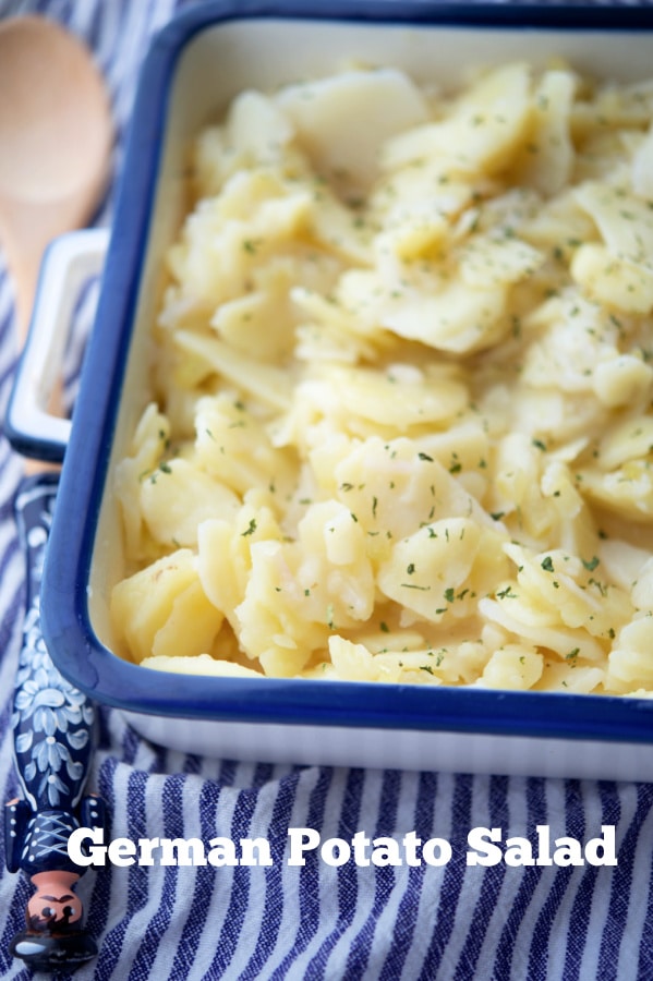 german potato salad in a white and blue dish