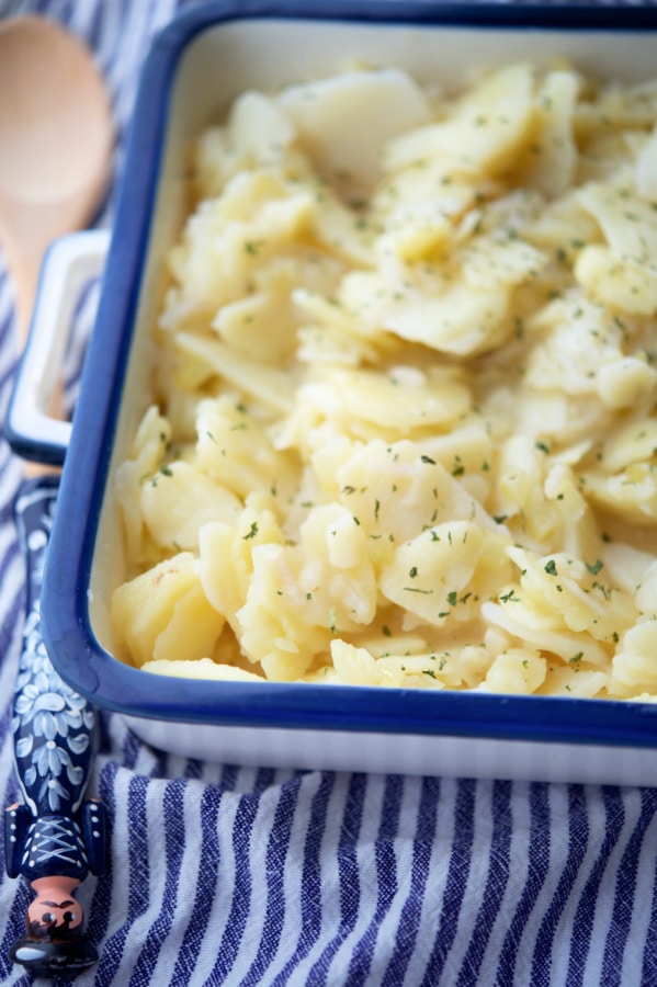 copycat otto's german potato salad in a blue and white dish