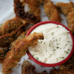 portobello mushroom fries on a white plate with a dipping sauce