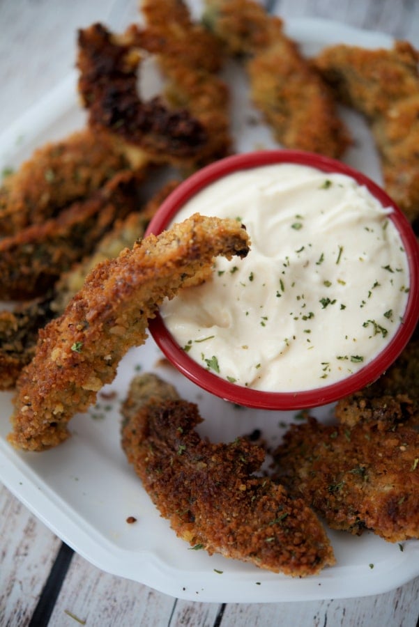 a mushroom fry dipping into a sauce