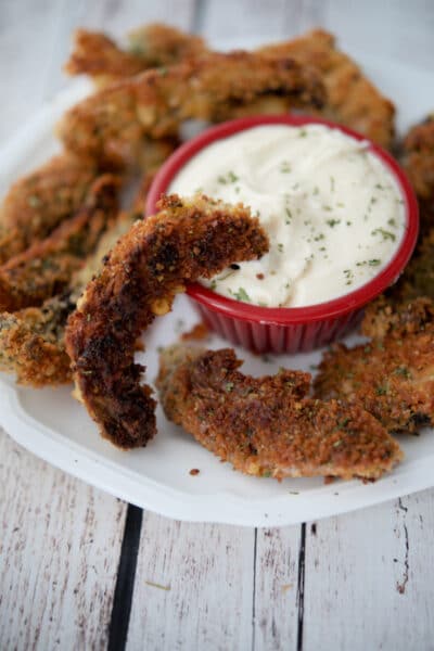 portobello mushroom fries on a plate with a garlic aioli