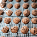 peanut butter brownie bites in a row on a cooling rack