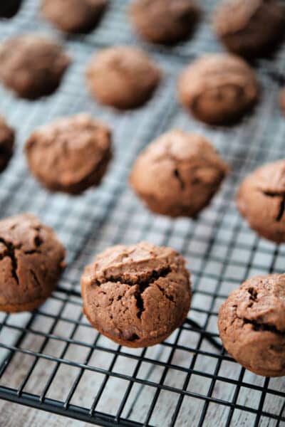 a close up of chocolate peanut butter brownie bites on a cooling rack
