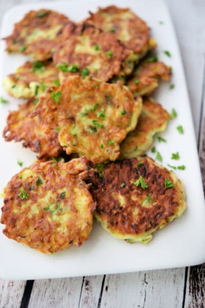 a plate of golden brown zucchini pancakes