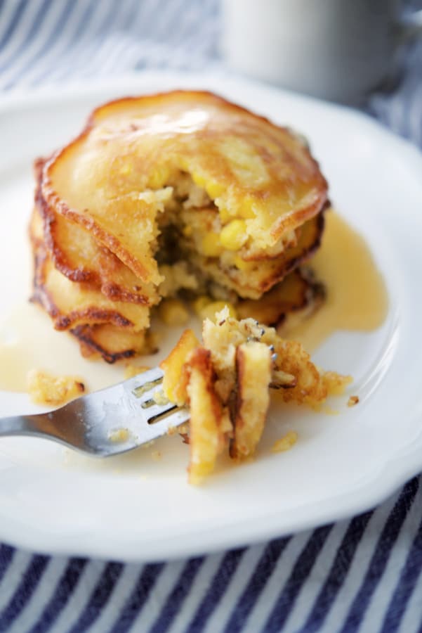 a stack of corn pancakes on a fork