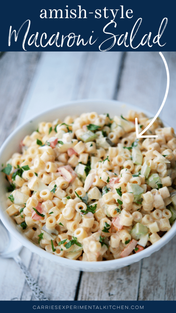 amish macaroni salad in a white bowl on wood planks