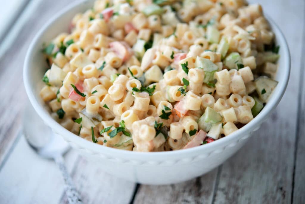 a white bowl filled with amish macaroni salad