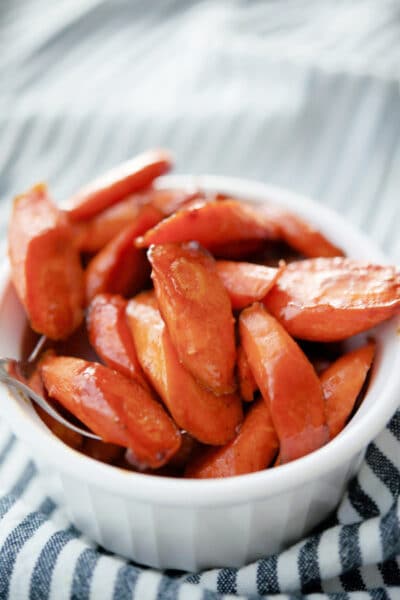 a white dish with sliced balsamic roasted carrots