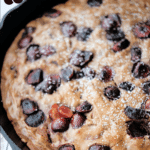 chocolate chunk cherry brownies in a cast iron skillet