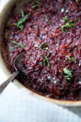 red wine risotto in a stainless steel skillet