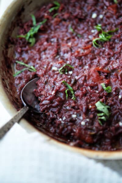 red wine risotto in a stainless steel skillet