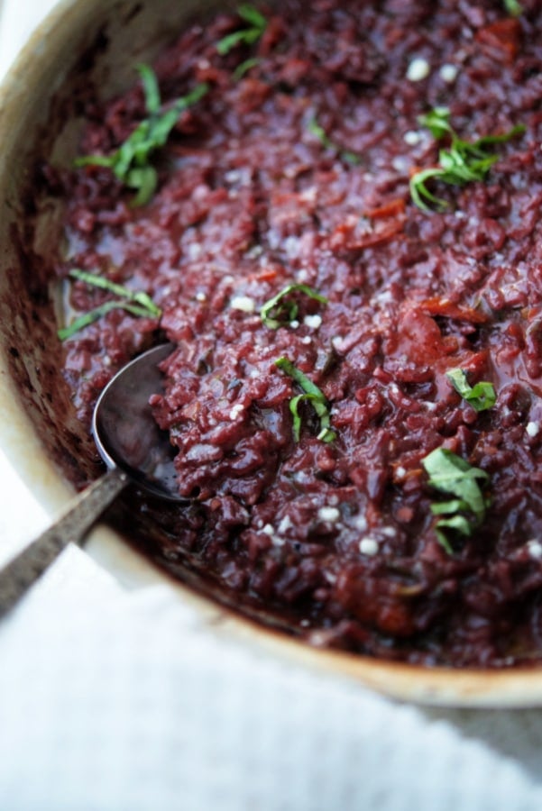 red wine risotto in a stainless steel skillet