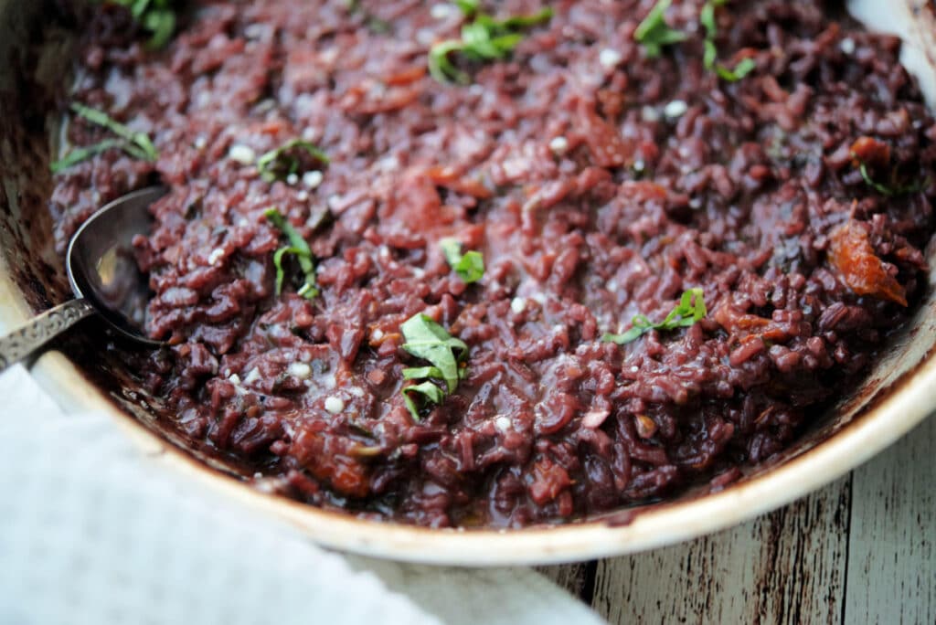 a close up of red wine risotto in a skillet