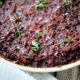 a close up of red wine risotto in a skillet