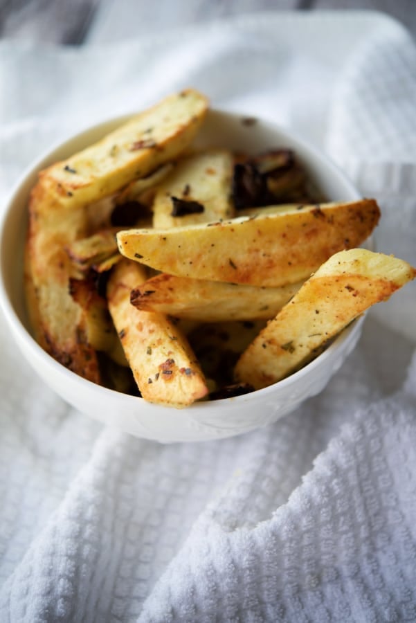 fennel roasted potato wedges in a white bowl