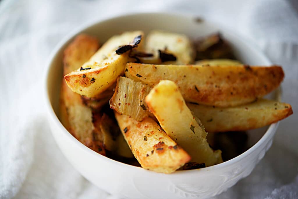 a bowl with fennel roasted potato wedges