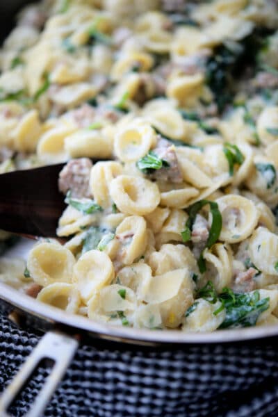 lemon ricotta orecchiette pasta in a skillet with sausage