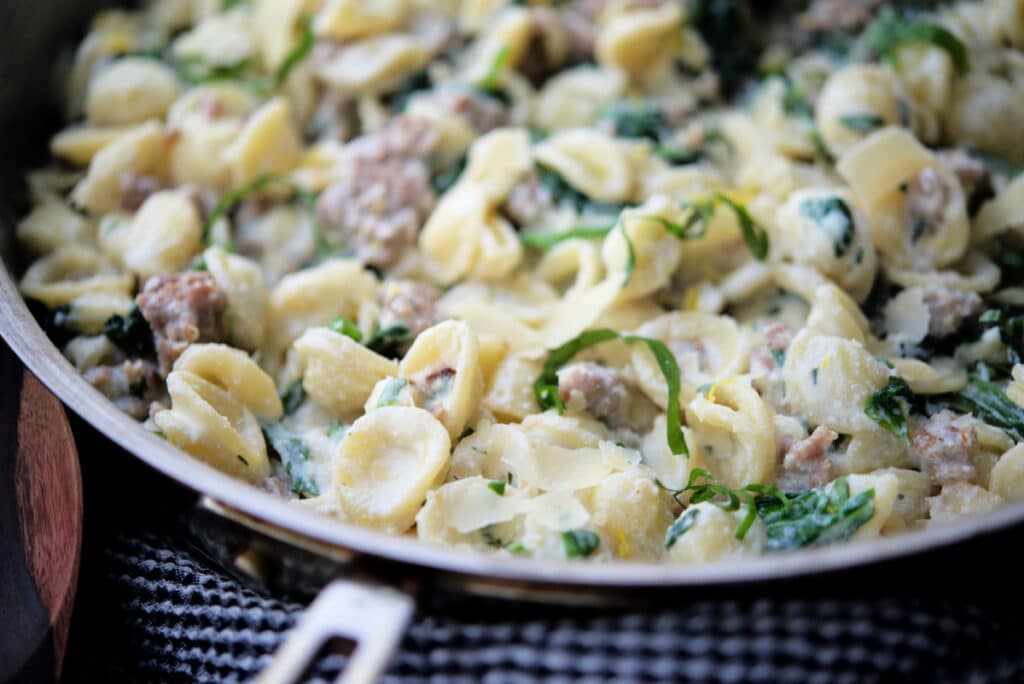 a close up of lemon ricotta pasta in a skillet