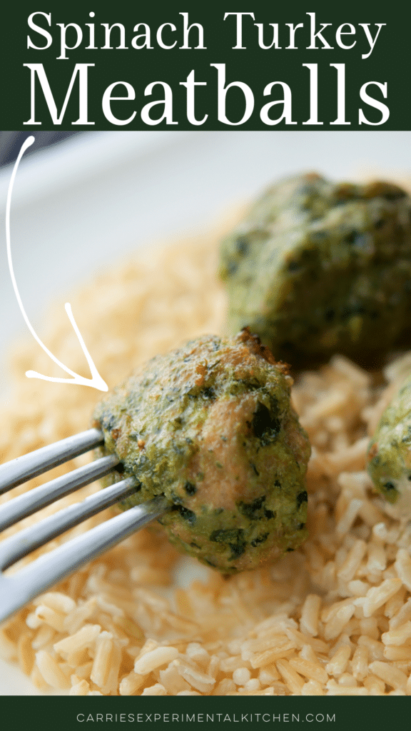 a close up of a spinach turkey meatball ona fork over brown rice