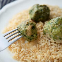spinach turkey meatballs over rice on a fork