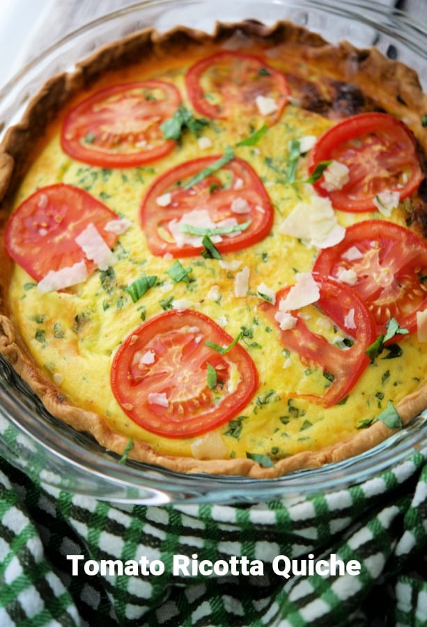 a quiche with sliced tomatoes on top