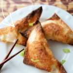cooked crab rangoons on a white dish