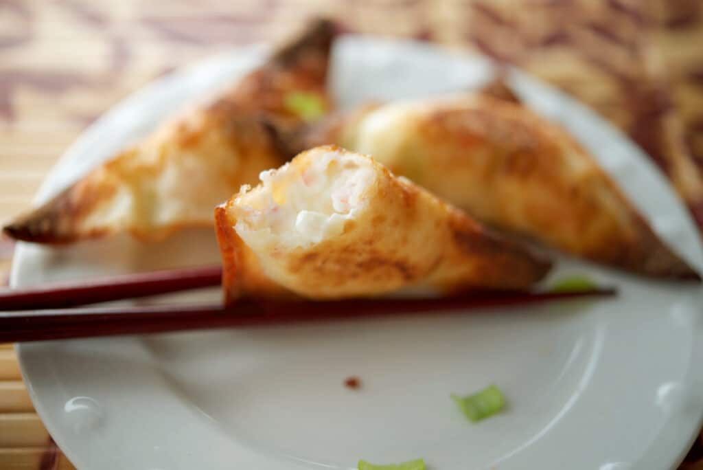 a close up of a crab rangoon inside filling