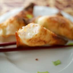 a close up of a crab rangoon inside filling
